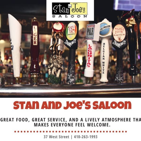 A close-up of various beer tap handles, including Lagunitas, Blue Moon, and Raging Bitch.